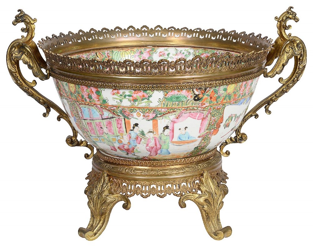 A nineteenth-century Cantonese Rose Medallion porcelain bowl held within ornate gilt-bronze ormolu mounts featuring mythical beast handles and a pierced base.