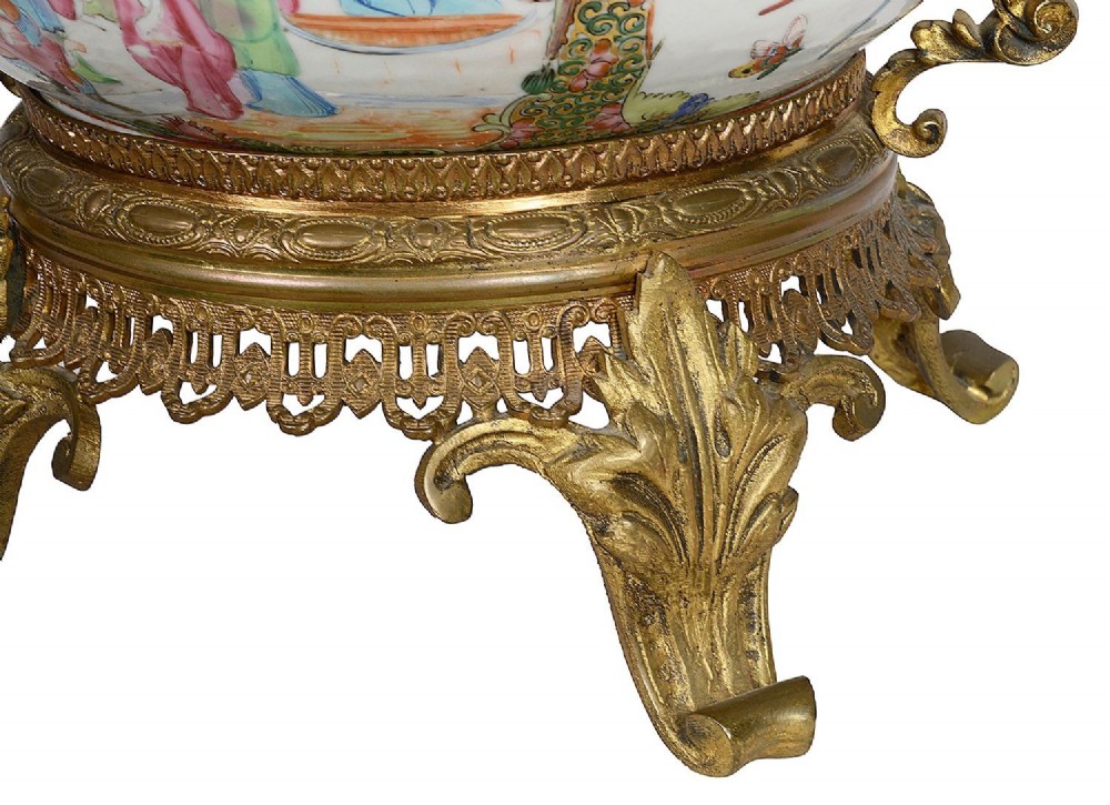 A nineteenth-century Cantonese Rose Medallion porcelain bowl held within ornate gilt-bronze ormolu mounts featuring mythical beast handles and a pierced base. View II