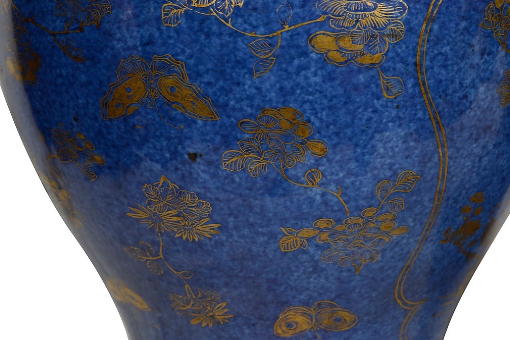 A pair of 19th-century powder blue porcelain baluster vases with gilt floral panels, domed covers, and decorative ormolu bases. View VI