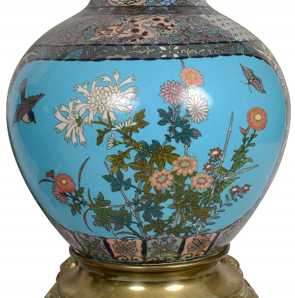 A pair of late nineteenth-century Japanese cloisonne table lamps with turquoise enamel floral bases, brass mounts, and cream pleated lampshades. View IV