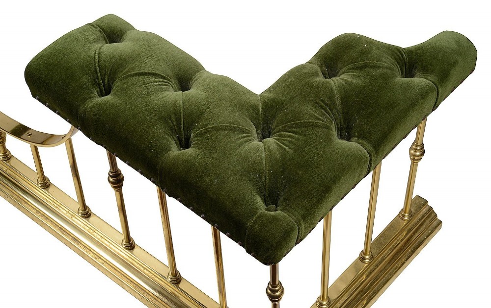 A Victorian brass club fender featuring vertical cylindrical spindles, a dipped front rail, and deep-buttoned green velvet corner seats with metal stud detailing. View II