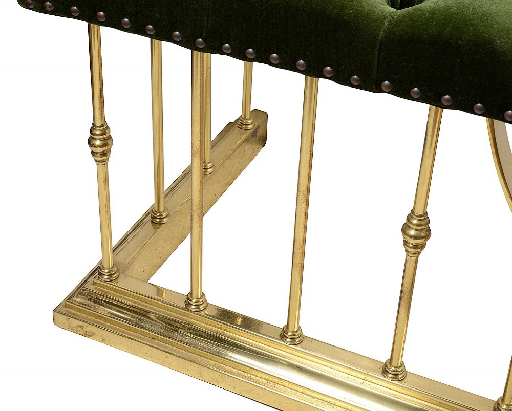 A Victorian brass club fender featuring vertical cylindrical spindles, a dipped front rail, and deep-buttoned green velvet corner seats with metal stud detailing. View III