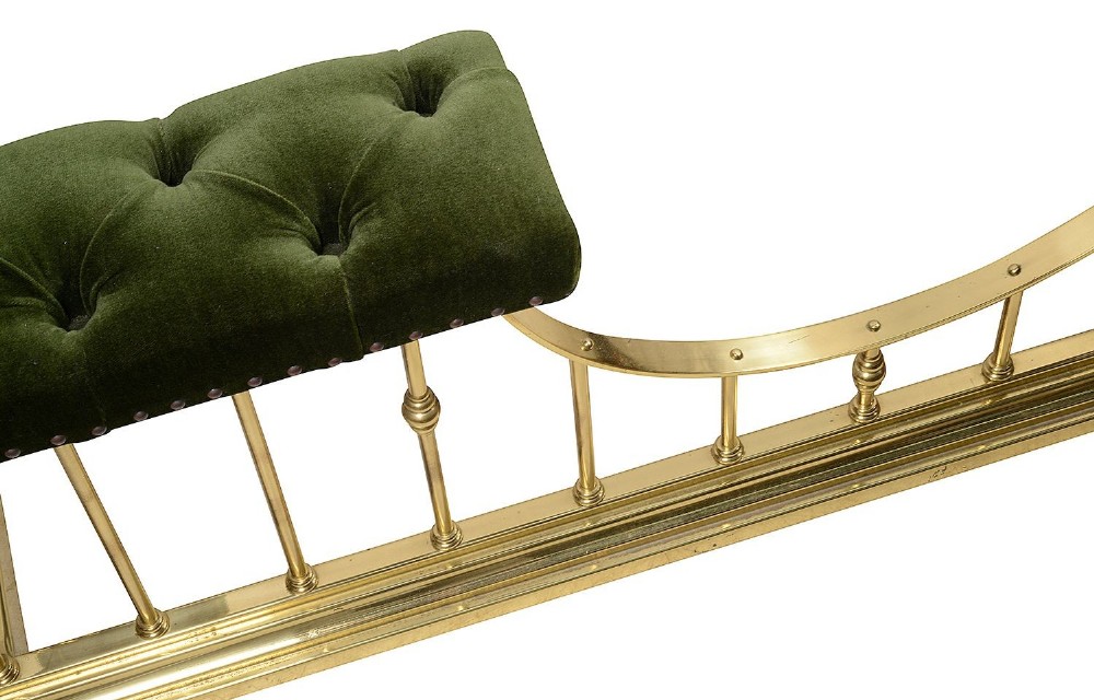 A Victorian brass club fender featuring vertical cylindrical spindles, a dipped front rail, and deep-buttoned green velvet corner seats with metal stud detailing. View IV