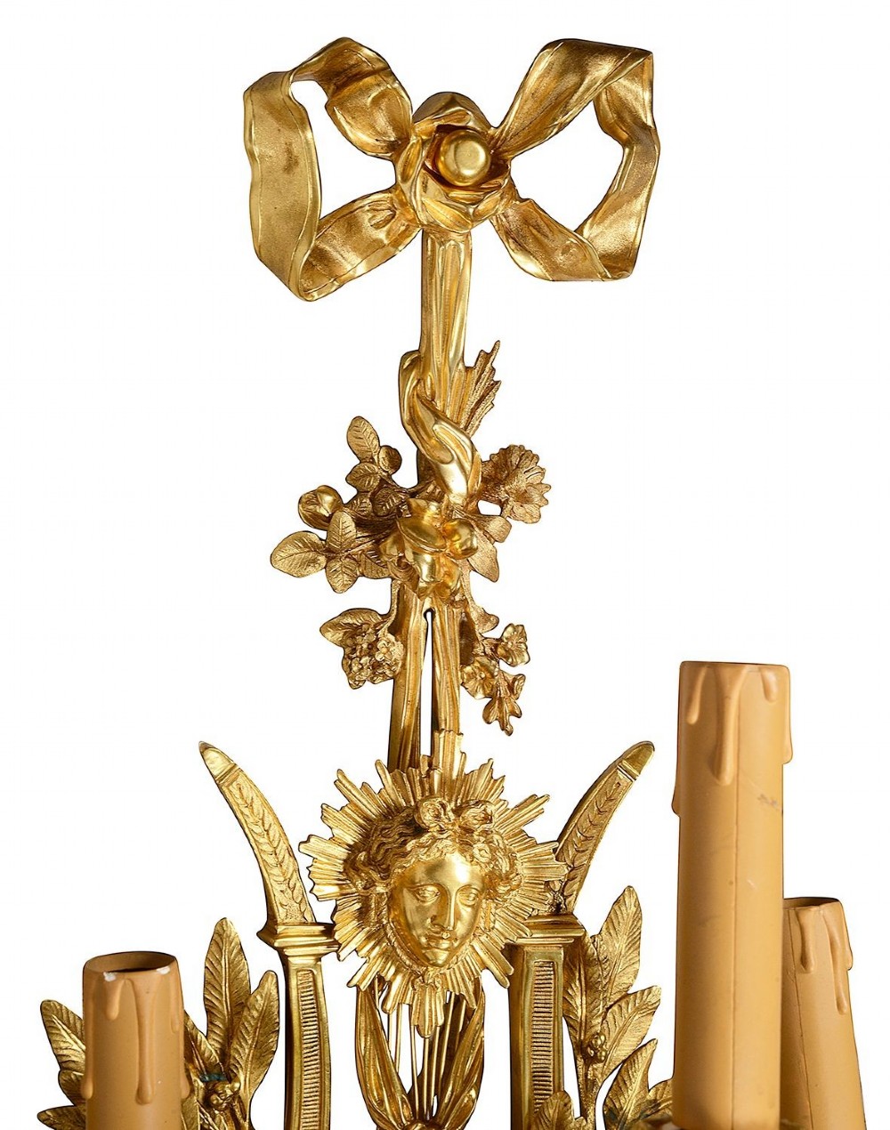 A set of six Louis XVI style gilded ormolu wall sconces featuring ribbon-bow finials and multi-arm candle holders adorned with leaf motifs. View IV