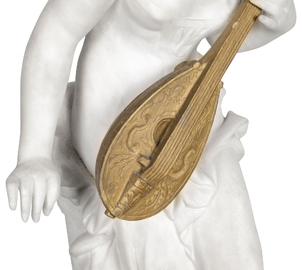 A carved white marble statue of a seated draped female musician playing a gilded lute on an integrated marble base. View VIII