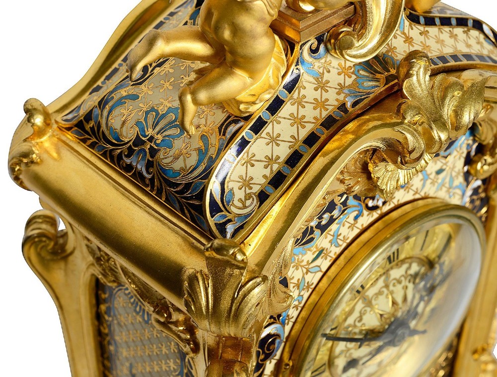 A 19th-century French Louis XVI style gilt bronze mantel clock decorated with multi-coloured enamel scrollwork and topped with twin cherub figures. View XI