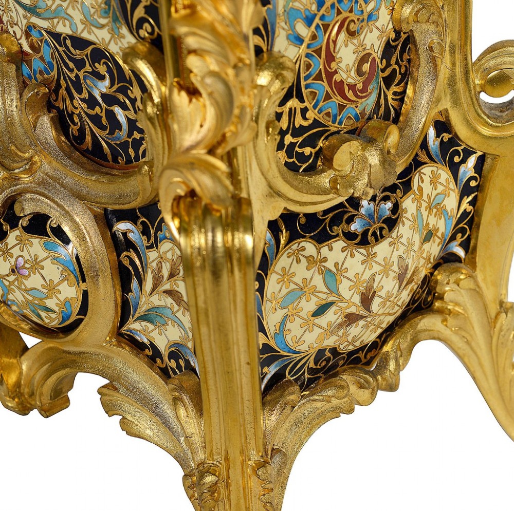 A 19th-century French Louis XVI style gilt bronze mantel clock decorated with multi-coloured enamel scrollwork and topped with twin cherub figures. View XII