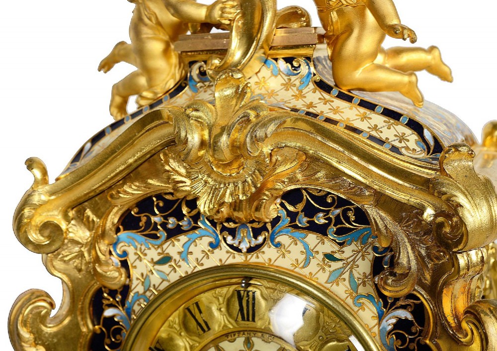 A 19th-century French Louis XVI style gilt bronze mantel clock decorated with multi-coloured enamel scrollwork and topped with twin cherub figures. View XIII