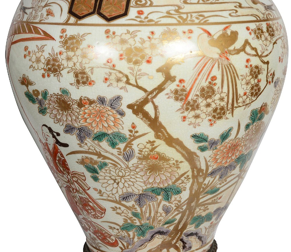 Pair of Japanese Arita Imari porcelain lidded vases featuring painted figures under umbrellas, standing on bronze bases with standing figure finials. View VI