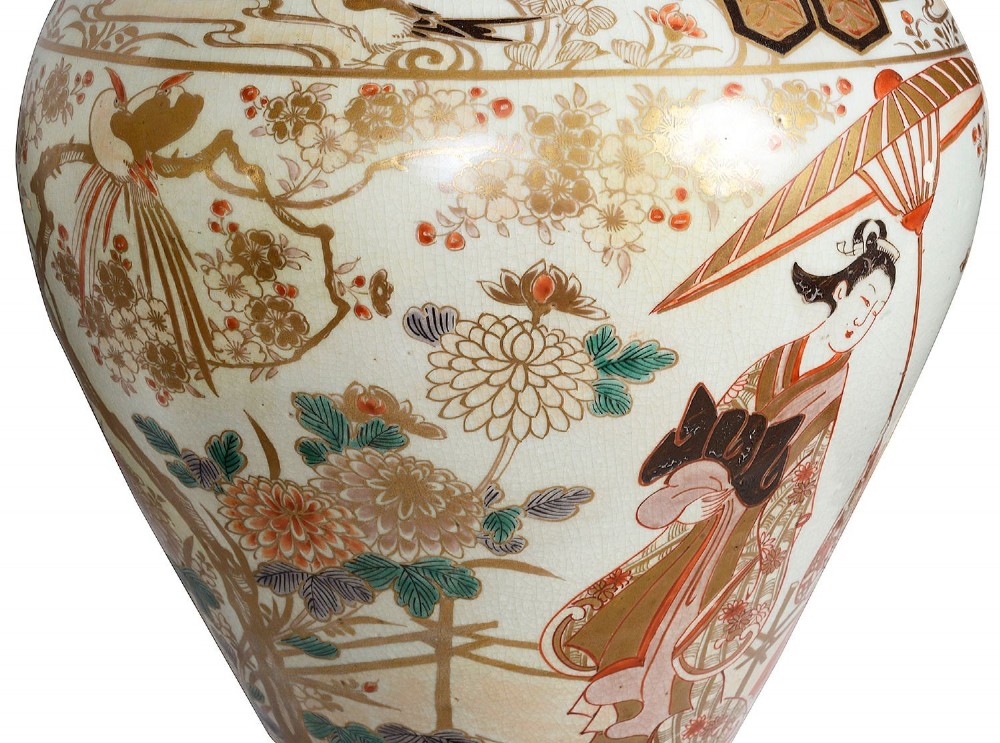 Pair of Japanese Arita Imari porcelain lidded vases featuring painted figures under umbrellas, standing on bronze bases with standing figure finials. View VIII