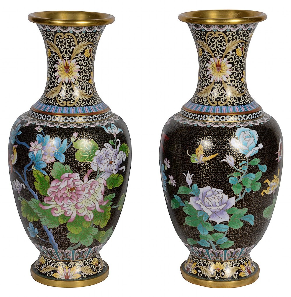 A matching pair of Chinese cloisonne vase table lamps featuring black enamel decorated with colourful floral motifs and butterflies, topped with cream off-white shades. View II