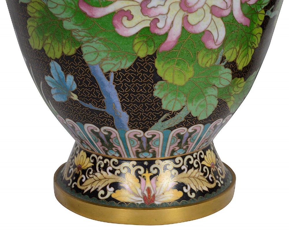 A matching pair of Chinese cloisonne vase table lamps featuring black enamel decorated with colourful floral motifs and butterflies, topped with cream off-white shades. View III