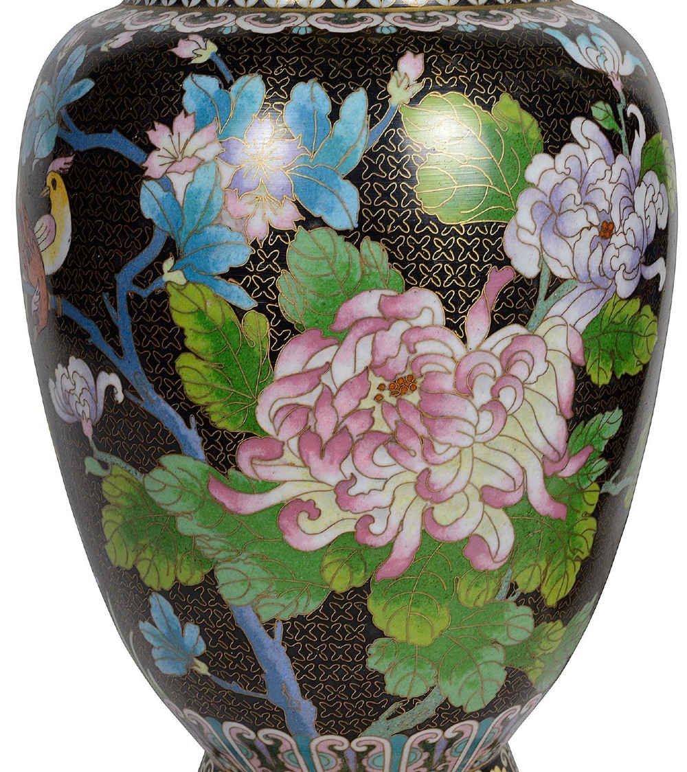 A matching pair of Chinese cloisonne vase table lamps featuring black enamel decorated with colourful floral motifs and butterflies, topped with cream off-white shades. View IV