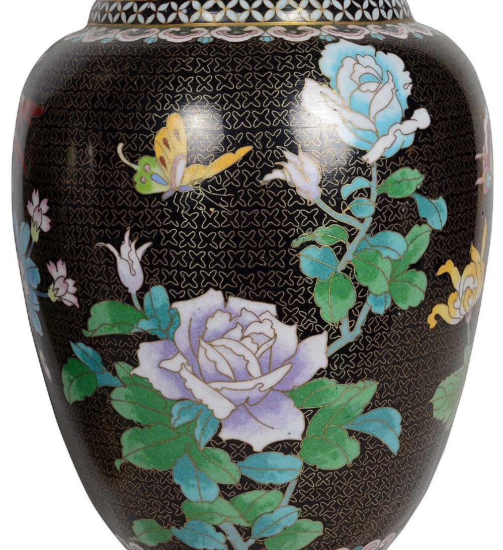 A matching pair of Chinese cloisonne vase table lamps featuring black enamel decorated with colourful floral motifs and butterflies, topped with cream off-white shades. View V
