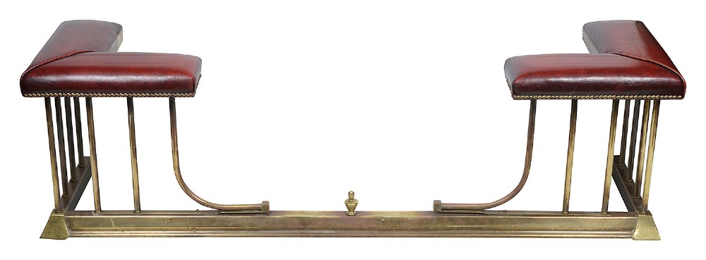 Late 19th-century brass club fender featuring twin red leather corner seats with stud trim and vertical brass spindles. View II