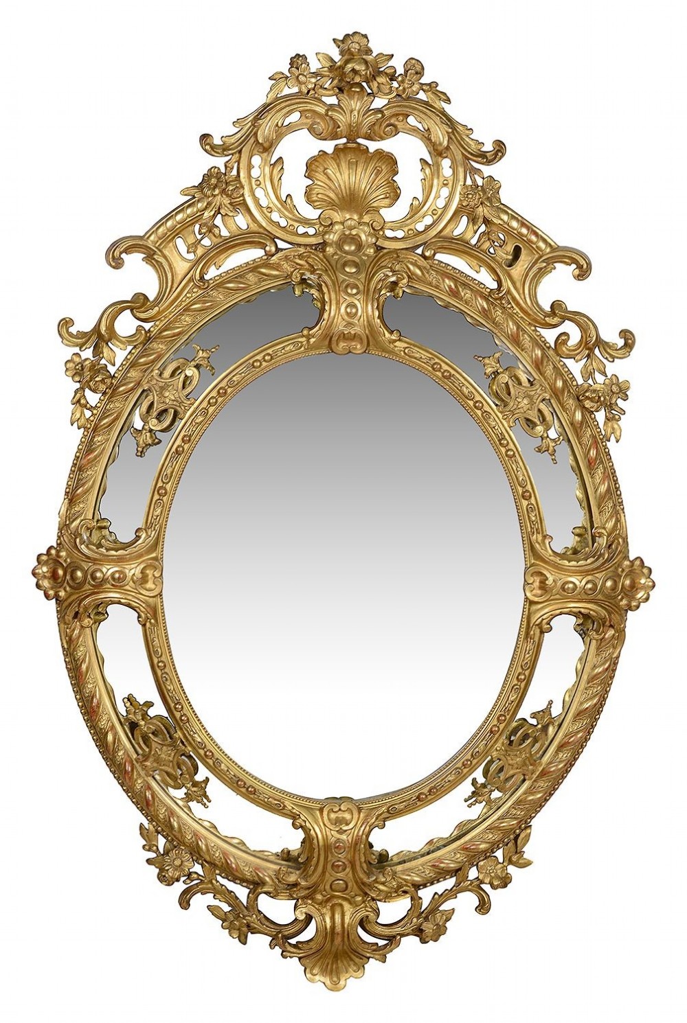 An ornate 19th-century oval wall mirror featuring a gilded wood and gesso frame with pierced scrollwork, shell cresting, and floral motifs.
