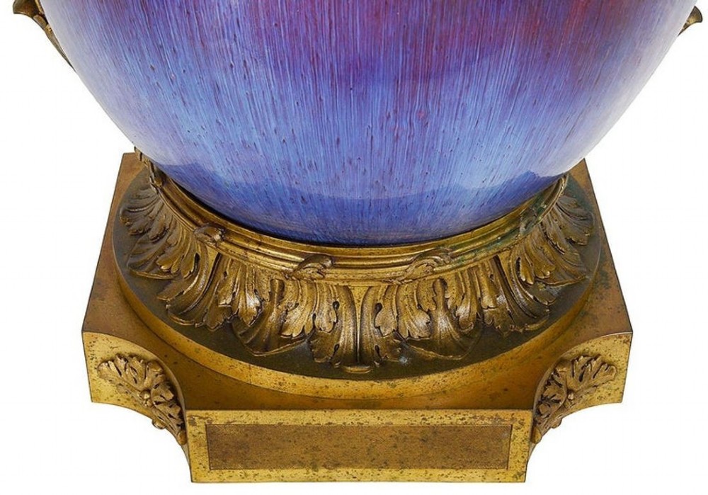 A sang de boeuf red and blue glazed ceramic urn lamp featuring gilt bronze handles and base with a pleated fabric shade. View V