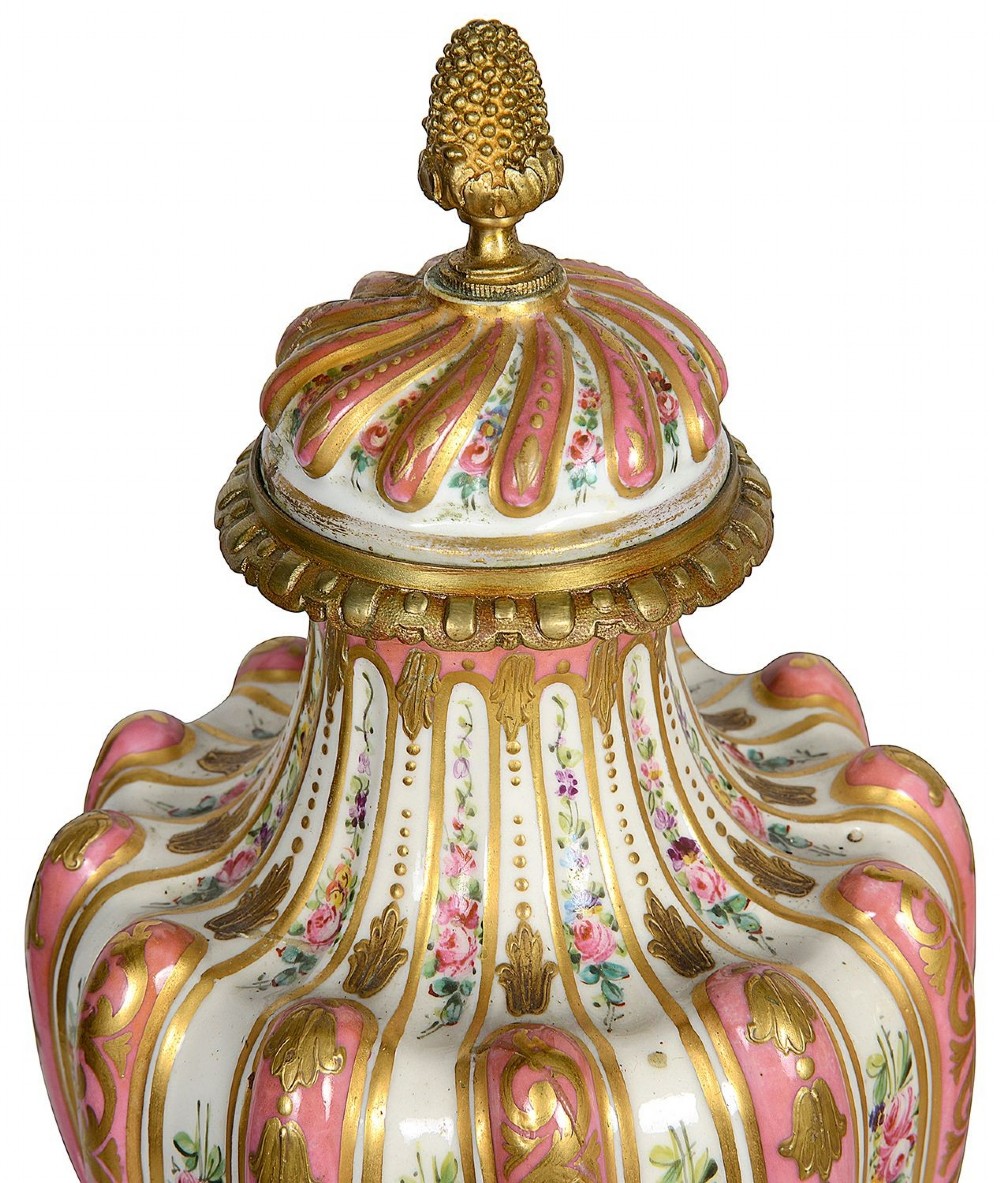 A pair of 19th-century French Sevres style pink and white porcelain lidded vases featuring hand-painted floral stripes and gilt decoration on square bases. View III