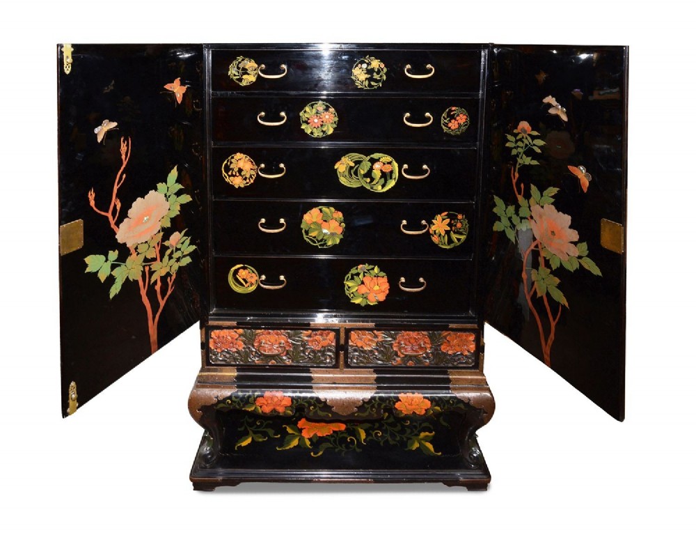A late nineteenth-century black and polychrome carved lacquer cabinet featuring relief peony and dragon motifs, fitted brass hardware, and a matching stand base. View VIII