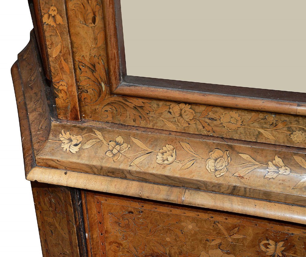 An 18th-century Dutch marquetry vitrine featuring detailed floral wood inlay, two glazed upper doors, a shaped bonnet top with carved shell cresting, a bombe three-drawer base, and claw-and-ball feet. View V