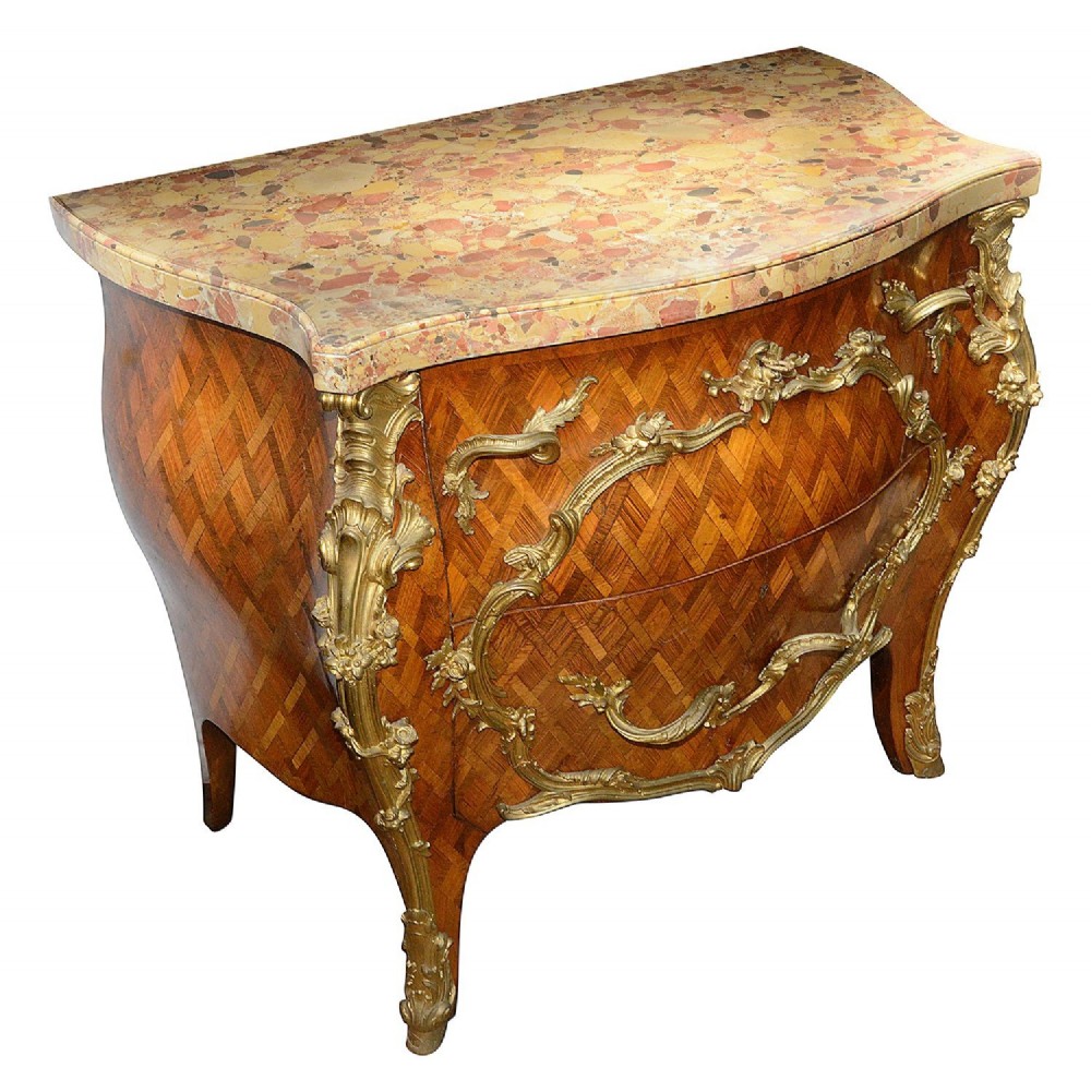A pair of French eighteenth-century style bombe commodes with geometric wood parquetry, intricate gilt-bronze mounts, and variegated marble tops. View III