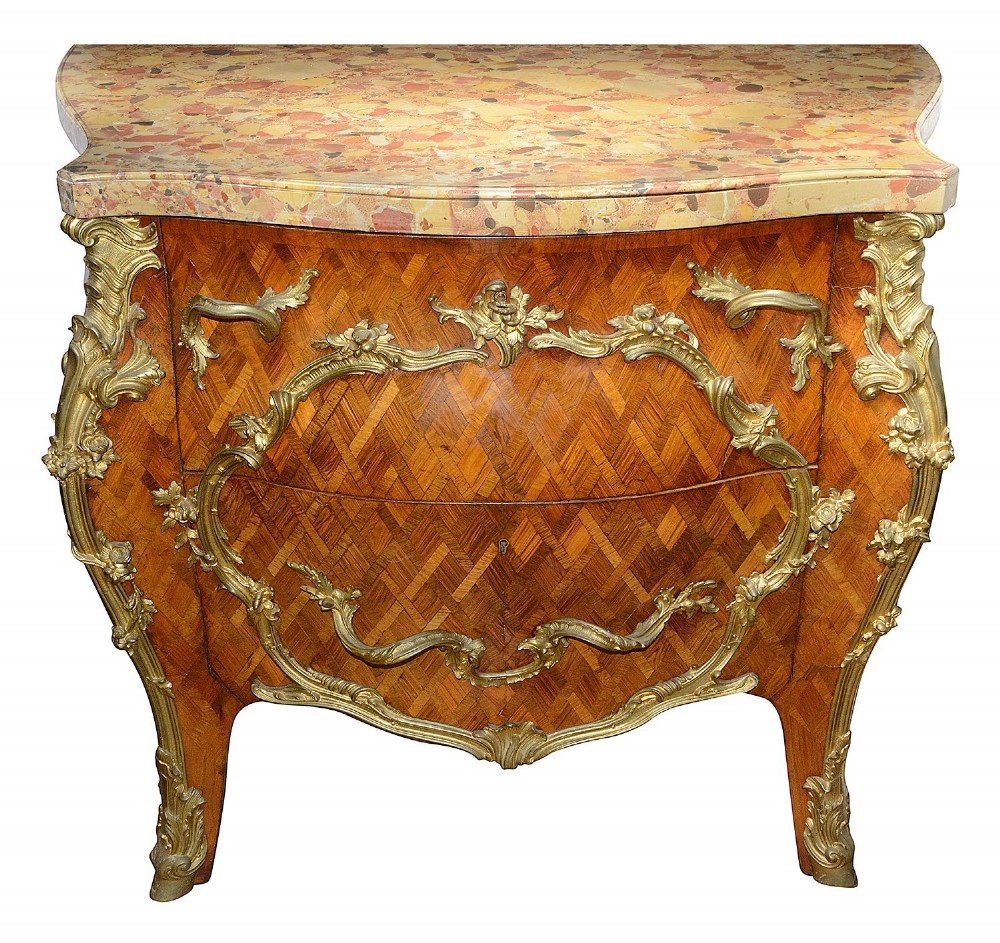 A pair of French eighteenth-century style bombe commodes with geometric wood parquetry, intricate gilt-bronze mounts, and variegated marble tops. View IV