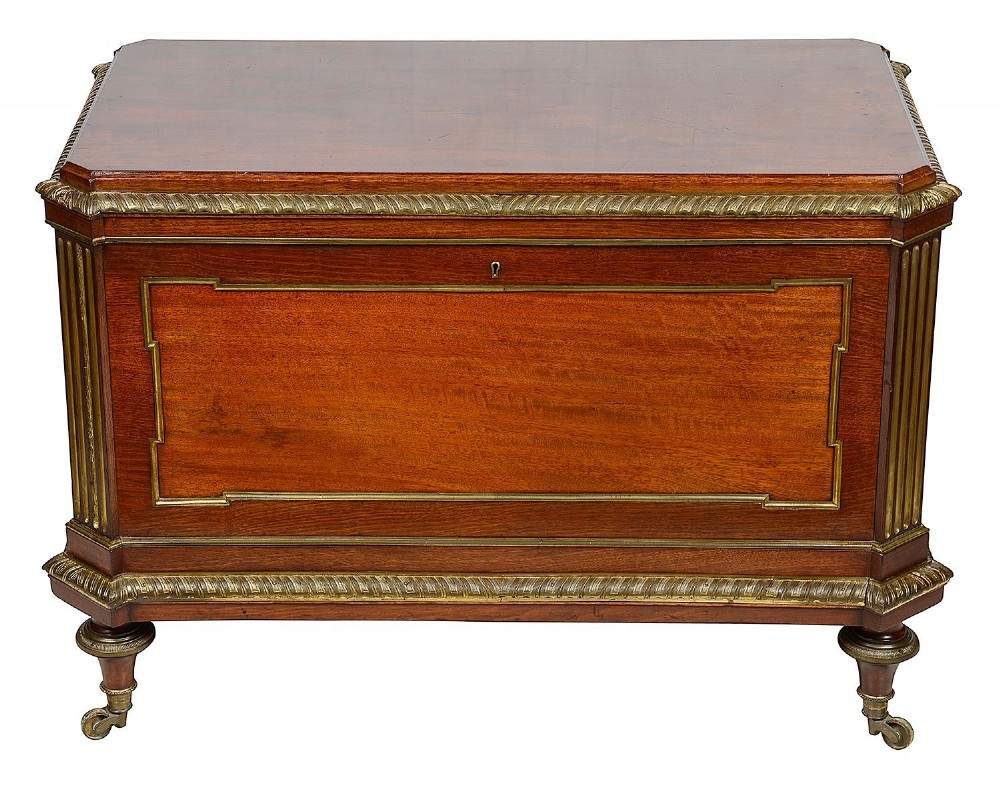 A rectangular French Louis XVI style mahogany cellarette featuring fluted corner columns, ornate brass egg-and-dart moulding, and tapered turned legs with castors. View II