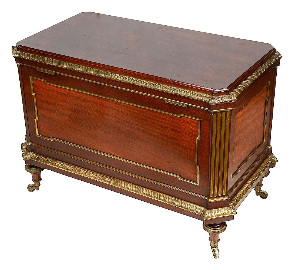 A rectangular French Louis XVI style mahogany cellarette featuring fluted corner columns, ornate brass egg-and-dart moulding, and tapered turned legs with castors. View IV