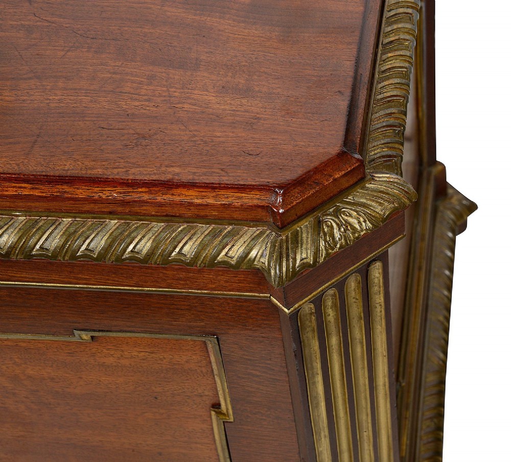 A rectangular French Louis XVI style mahogany cellarette featuring fluted corner columns, ornate brass egg-and-dart moulding, and tapered turned legs with castors. View V
