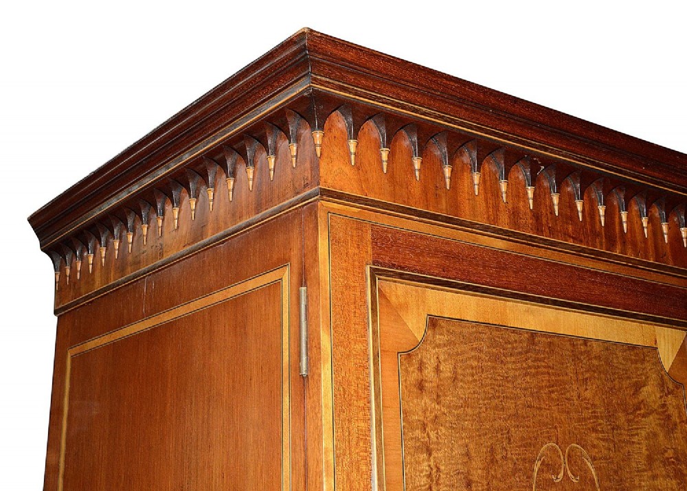 An Edwardian mahogany two door wardrobe featuring intricate neoclassical satinwood inlay on the door panels and lower drawer. View III