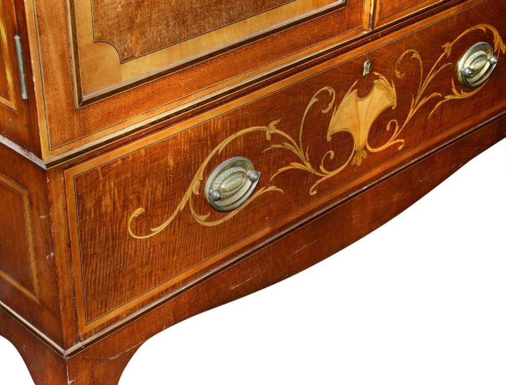 An Edwardian mahogany two door wardrobe featuring intricate neoclassical satinwood inlay on the door panels and lower drawer. View V