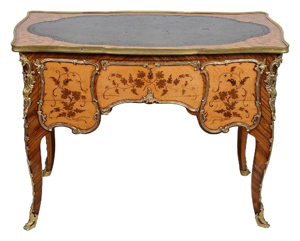 A 19th-century French Rococo Revival marquetry bureau de dame featuring floral timber inlays, serpentine edges, leather inset top, and gilt-bronze mounts on cabriole legs. View II