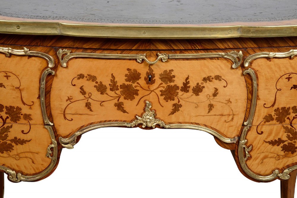 A 19th-century French Rococo Revival marquetry bureau de dame featuring floral timber inlays, serpentine edges, leather inset top, and gilt-bronze mounts on cabriole legs. View III