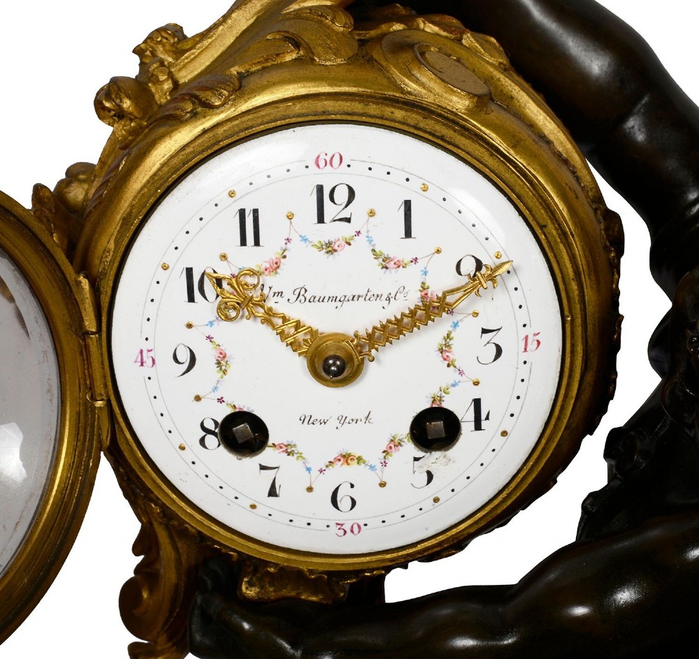 A 19th-century French classical mantel clock featuring a dark patinated bronze cherub seated on an ornate gilded scroll base holding a gilt-framed dial. View II