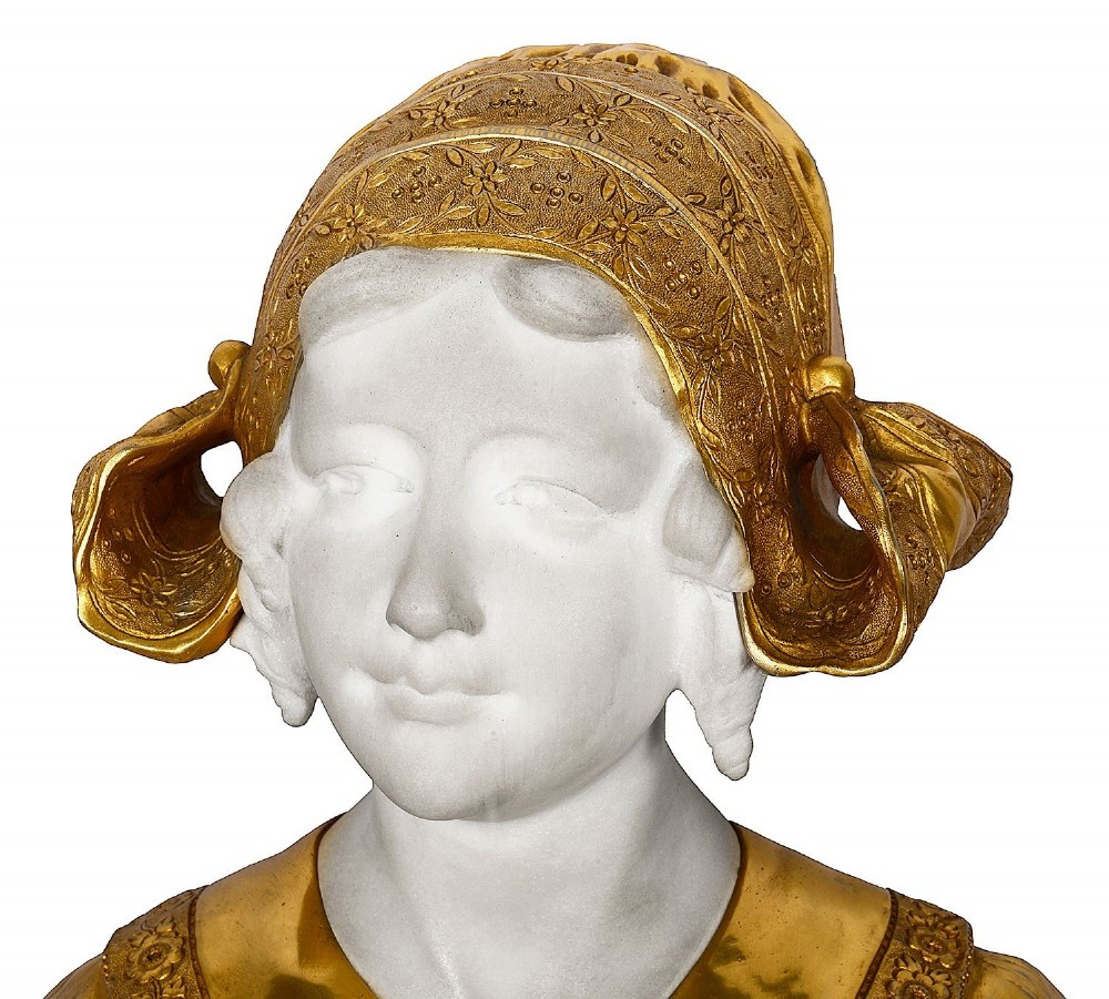 A nineteenth-century carved white marble bust of a young Dutch girl featuring an ornate gilded bonnet and lace collar, raised on a square marble plinth. View III