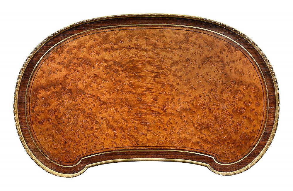A Louis XVI style kidney-shaped two-tier side table featuring burr walnut veneer, a pierced brass gallery, and gilt-bronze mounts. View III