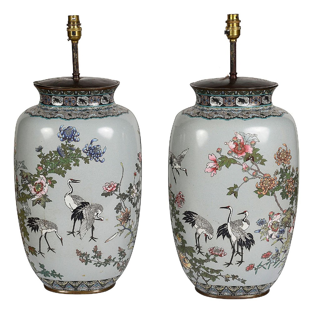 A pair of Japanese cloisonne enamel vase table lamps decorated with cranes and floral motifs on a light blue ground with cream pleated shades. View II