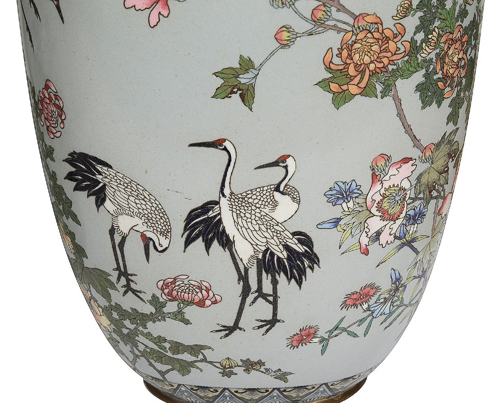 A pair of Japanese cloisonne enamel vase table lamps decorated with cranes and floral motifs on a light blue ground with cream pleated shades. View V