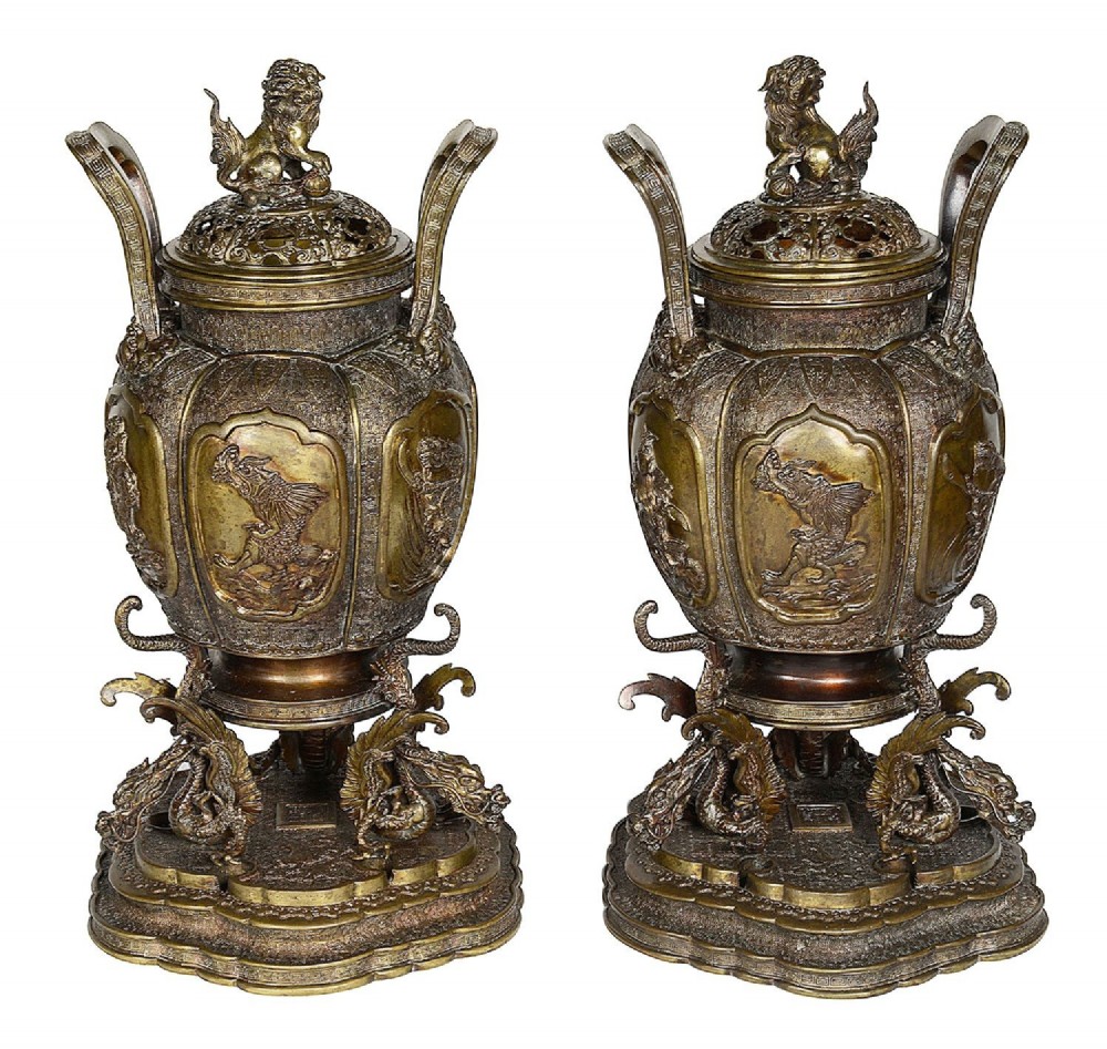 A pair of ornate antique Japanese Meiji period bronze lidded censers featuring dragon bases, relief panels, and shishi lion finials. View II