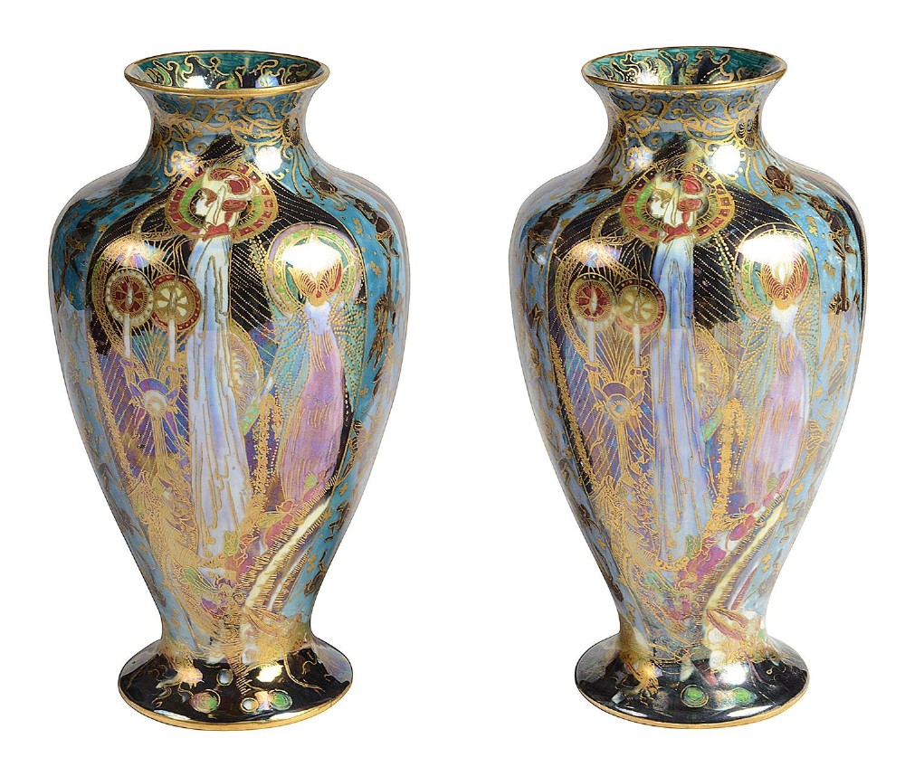 A pair of baluster-shaped Wedgwood Fairyland Lustre vases featuring the Candlemas pattern with iridescent blue background and elaborate gold gilding.