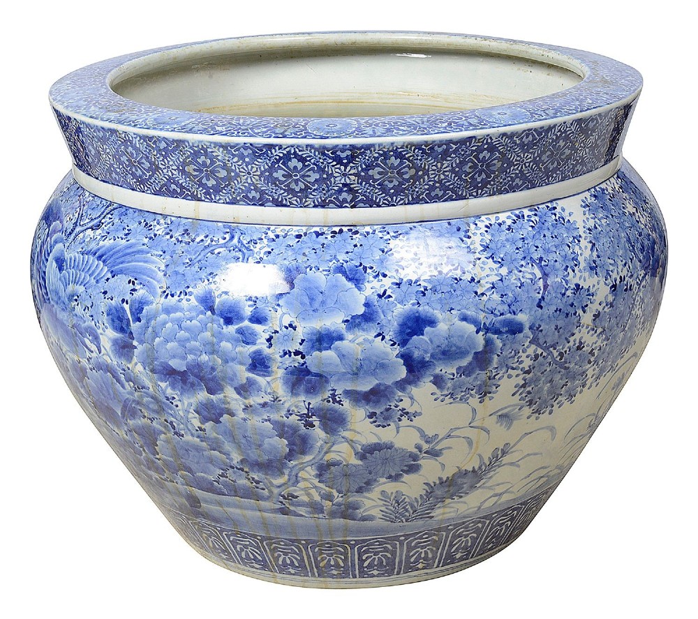 A large round Japanese blue and white porcelain jardiniere featuring intricate hand-painted floral patterns and bird motifs. View III