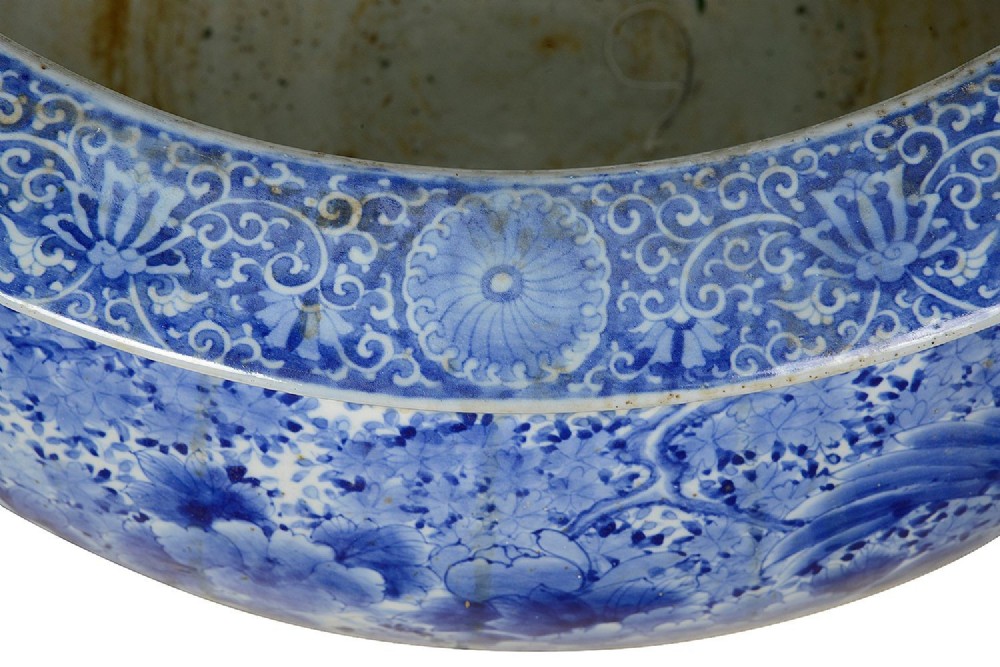 A large round Japanese blue and white porcelain jardiniere featuring intricate hand-painted floral patterns and bird motifs. View VII
