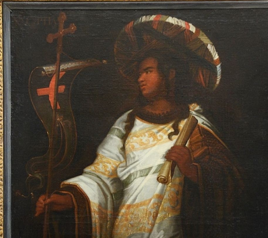 A pair of full-length 18th-century oil paintings depicting classical female figures in draped ochre gowns within matching carved gilt frames. View V