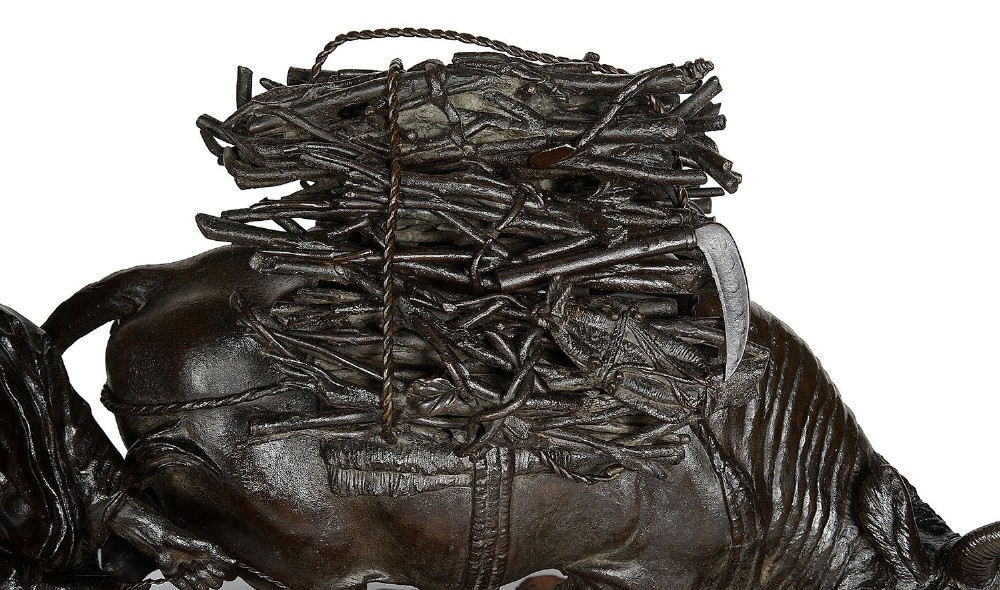 A dark patinated bronze Meiji period sculpture depicting a woodsman guiding a water buffalo laden with firewood, mounted on a rustic carved burr wood base. View VI
