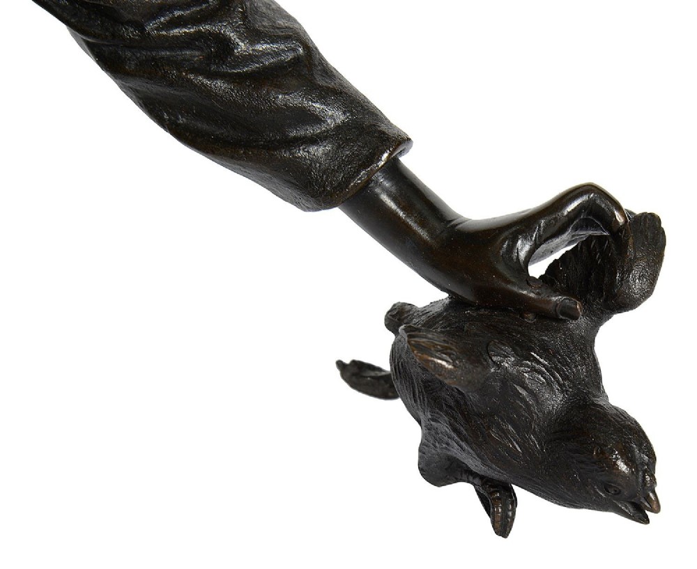 A dark brown patinated Japanese bronze sculpture depicting a crouching girl in traditional robes gathering chickens, dating to the late nineteenth century. View VII
