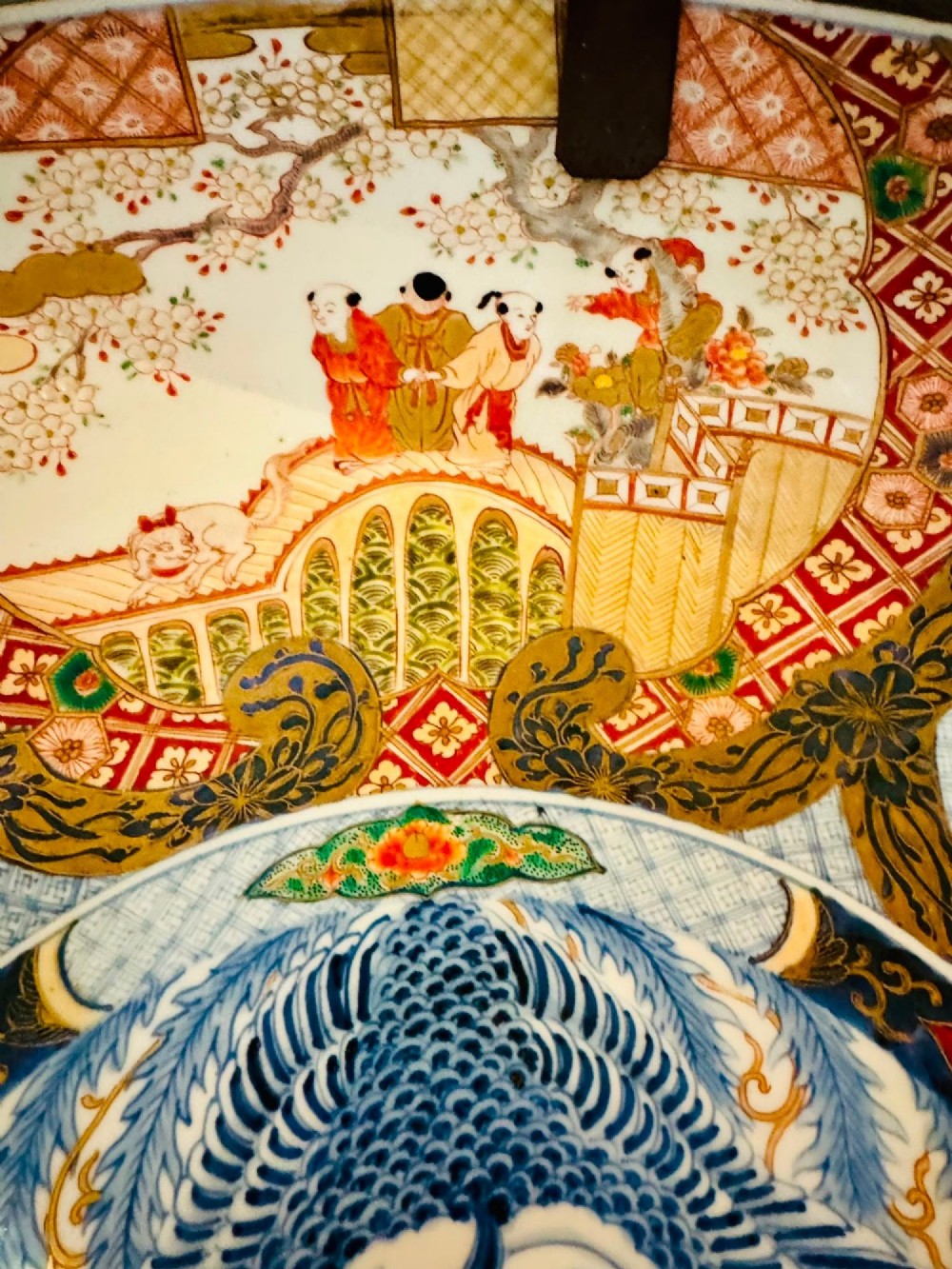 A circular 19th-century Japanese Imari porcelain charger featuring a central blue phoenix motif surrounded by intricate panels with figures, dragons, and floral patterns in blue, red, green, and gold. View VIII