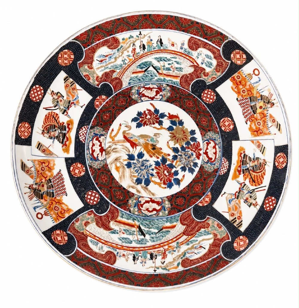A large 19th-century Japanese Imari porcelain charger featuring hand-painted samurai panels and floral medallions in rust red, blue, and gold.