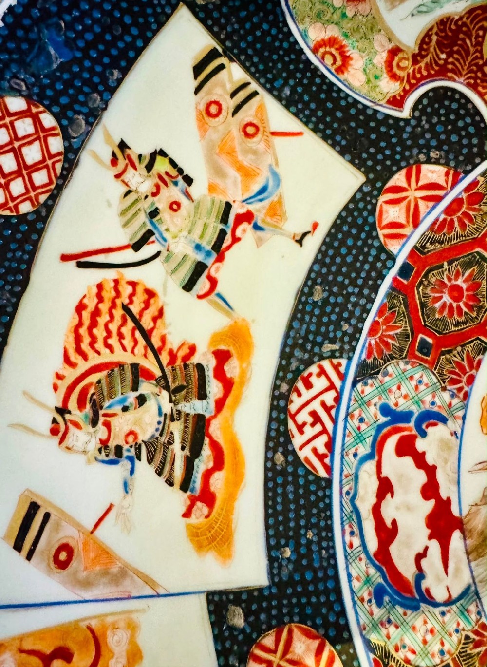 A large 19th-century Japanese Imari porcelain charger featuring hand-painted samurai panels and floral medallions in rust red, blue, and gold. View II