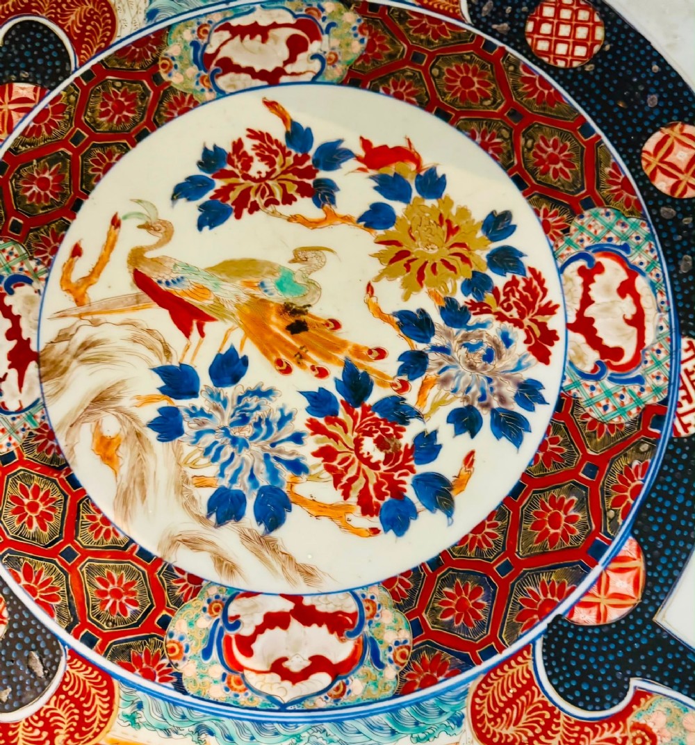 A large 19th-century Japanese Imari porcelain charger featuring hand-painted samurai panels and floral medallions in rust red, blue, and gold. View III