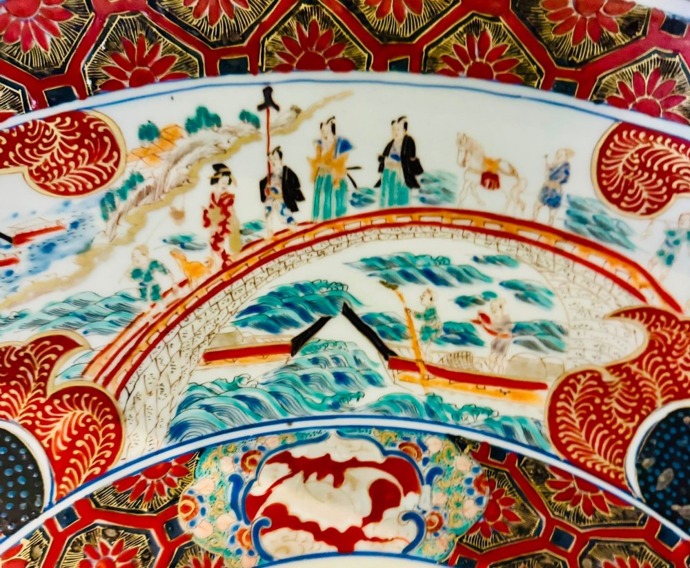 A large 19th-century Japanese Imari porcelain charger featuring hand-painted samurai panels and floral medallions in rust red, blue, and gold. View V